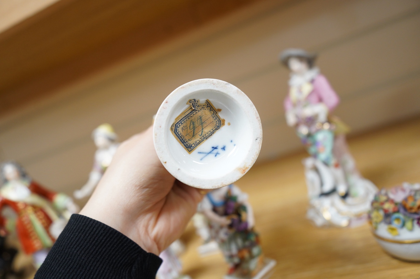 Eight various German porcelain figures, some with crossed sword marks to the bases and a floral encrusted pot and cover, largest 19cm high. Condition - fair, some losses